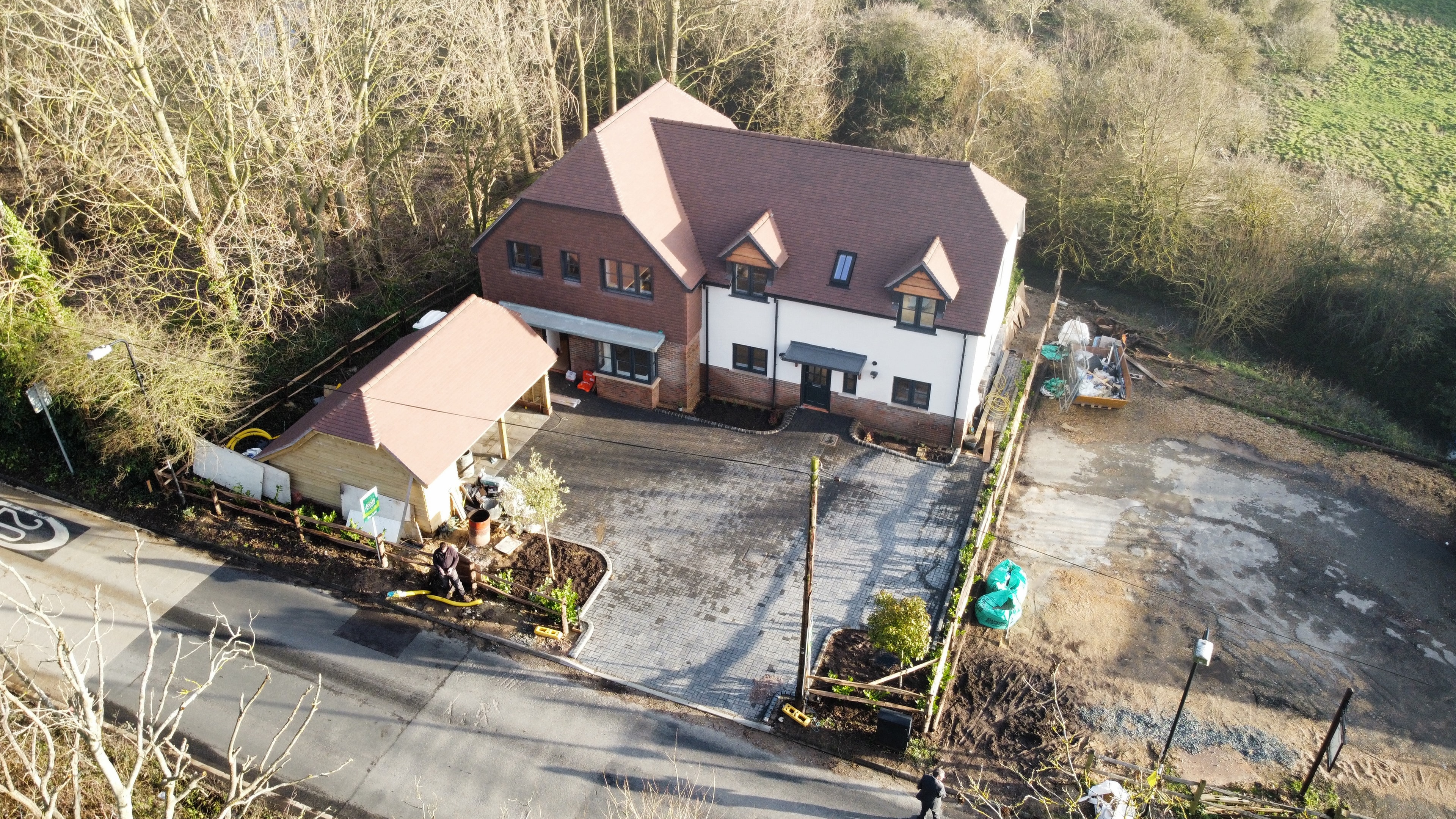 Block paving driveway with car port in Angmering : Multi car driveway with wooden car port clean edging and guest parking